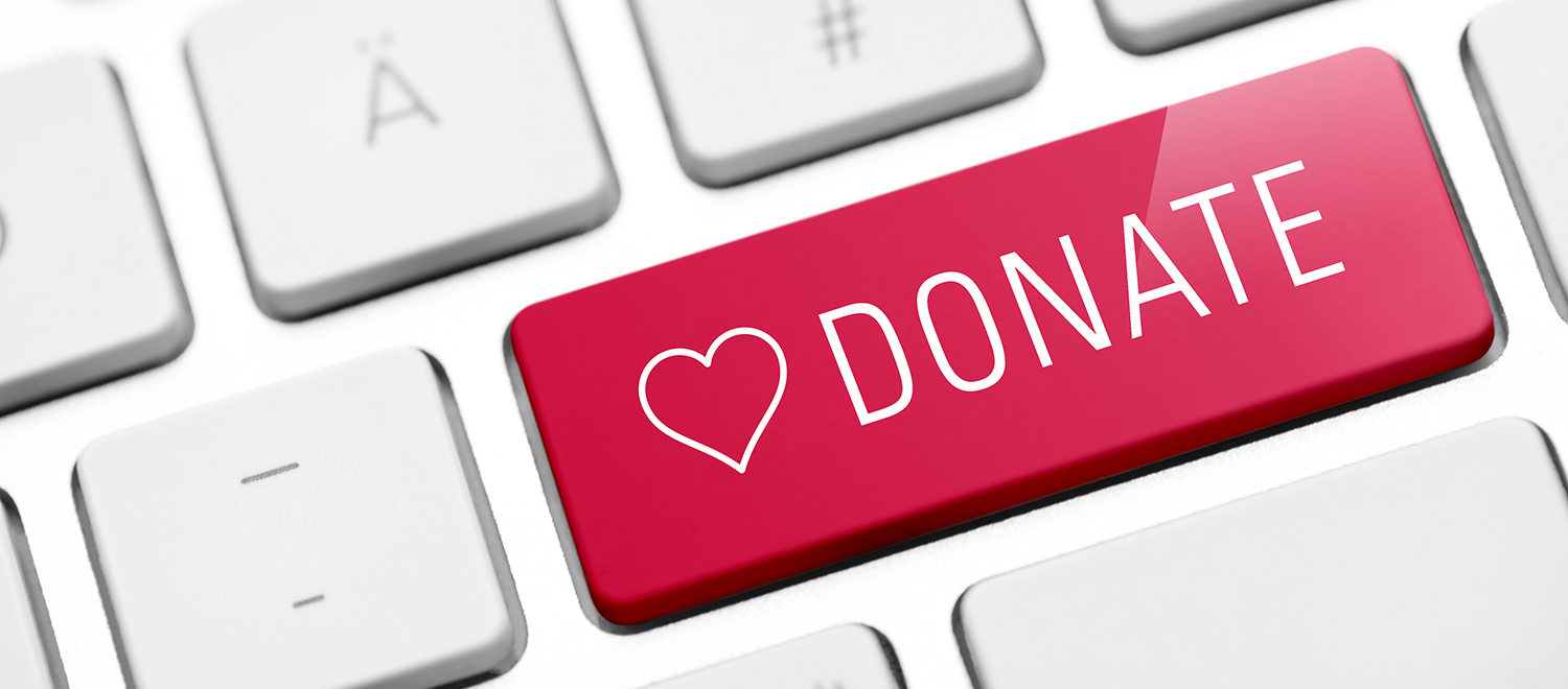 Part of keyboard with red button with a heart and the word donate.