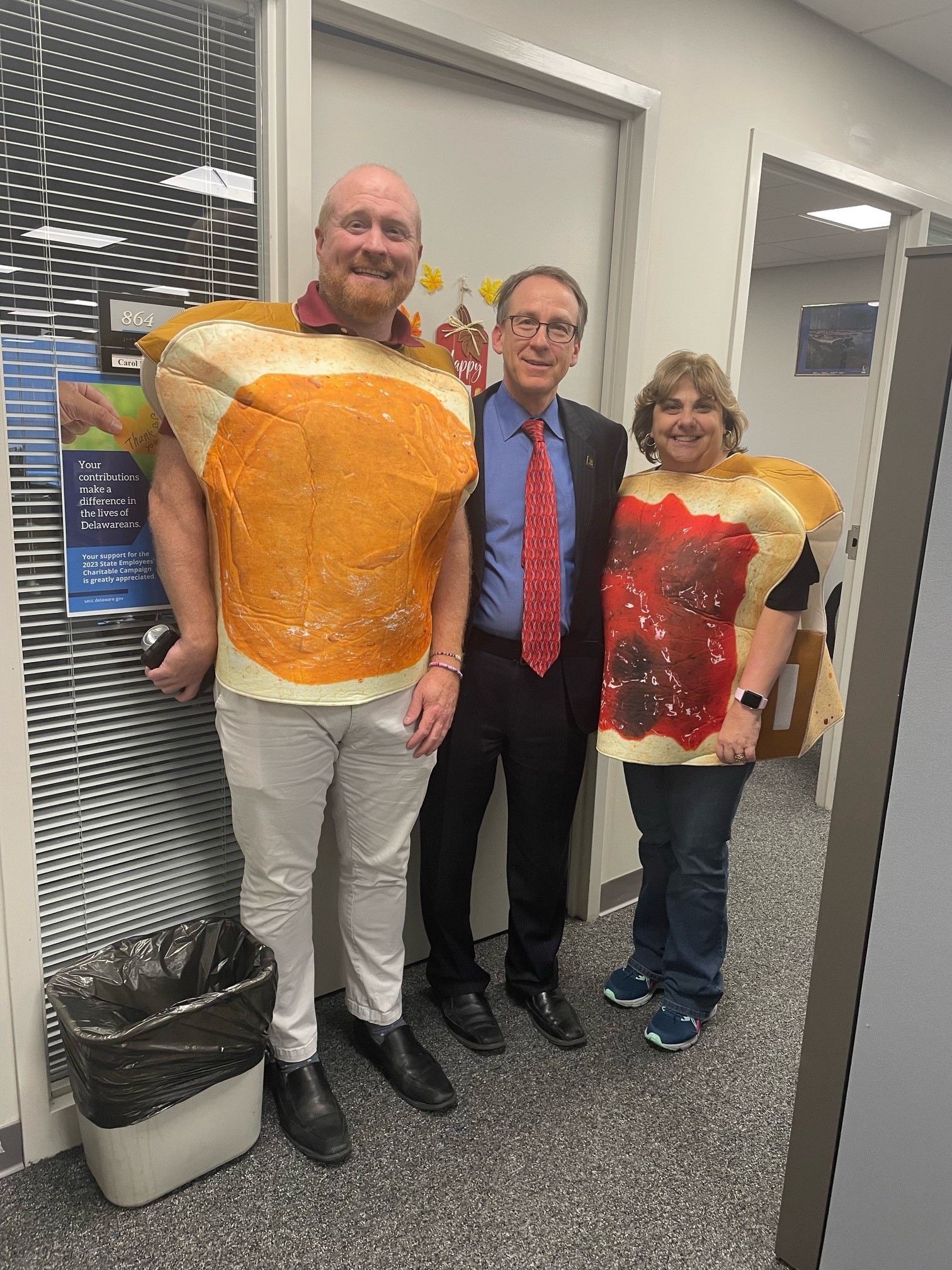 two people wearing costumes. one in peanut butter and the other in jelly with Cabinet Secretary of Finance