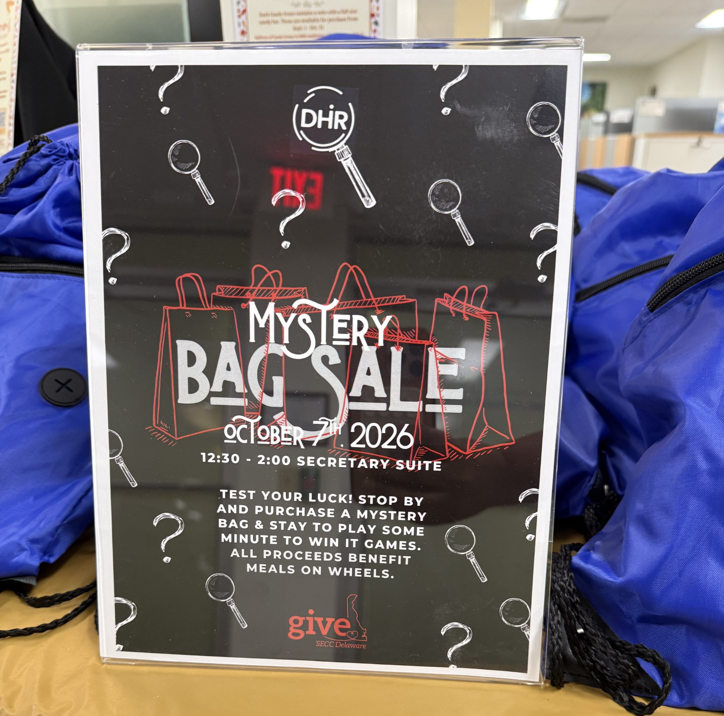 Sign of Mystery Bag sale in front of bags.